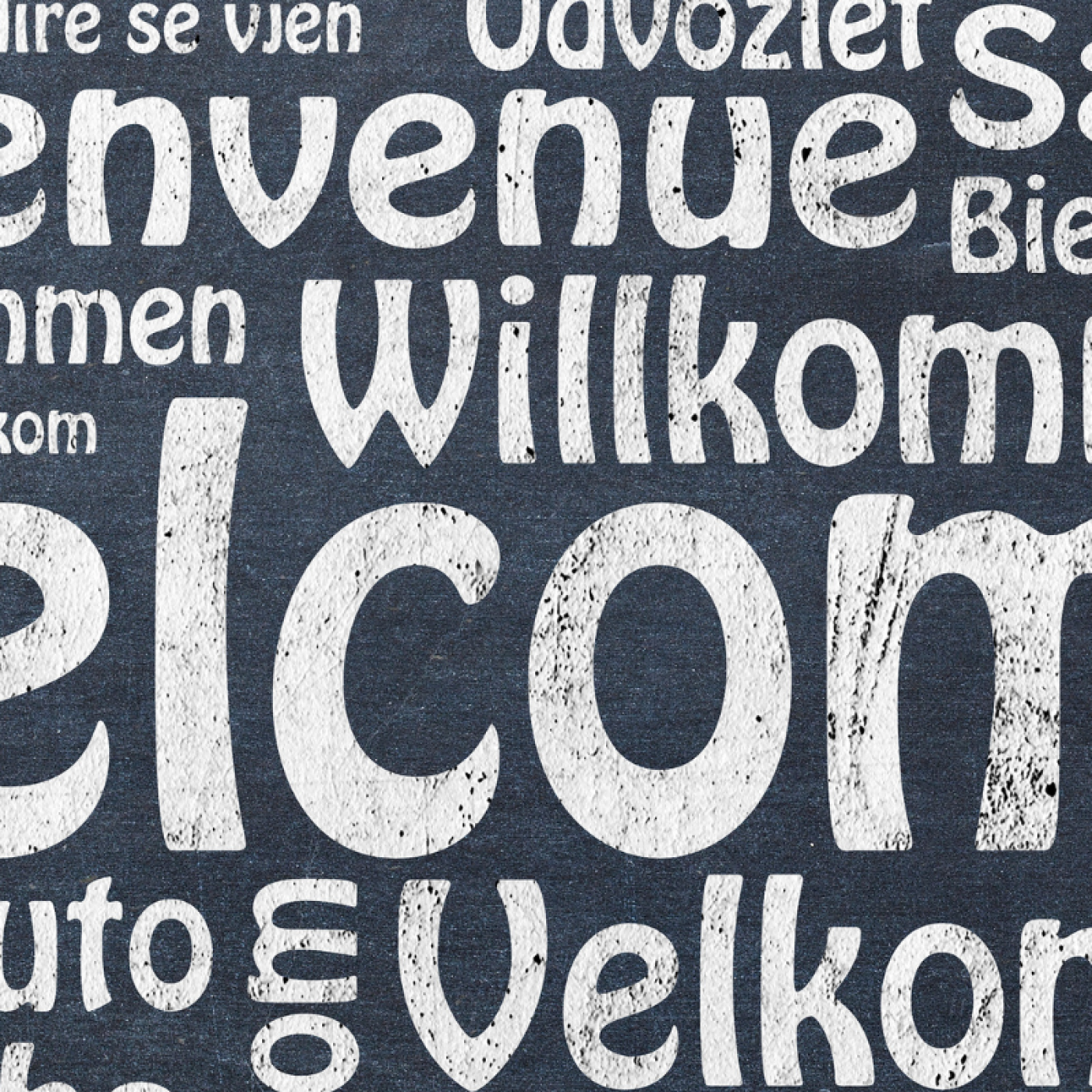 welcome in white text in many languages. 